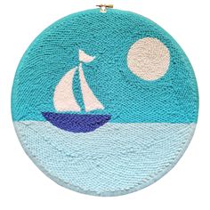 a blue and white rug with a sailboat on it