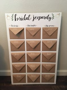 a brown paper bag with the words bridal souvenary written on it, sitting next to a white wall