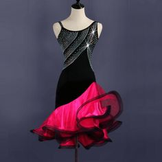 a mannequin wearing a black and pink dress with sequins on it