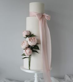 a white cake with pink flowers on top