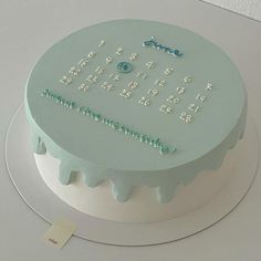 a white cake with blue frosting and numbers on it