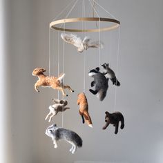 several stuffed animals are hanging from a mobile