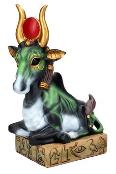 a statue of a bull sitting on top of a box