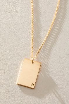 So unique in an understated design, this stunning necklace features a personalized rectangle pendant with initial engraved at corner for a super fun finishing touch. * 14k Gold Filled * 0.5x0.75" rectangle bar necklace with hand-stamped personalization * Length: 20" * 5 days of production | Set & Stones Personalized ie Necklace at Free People in Gold Rectangle Pendant, Engraved Necklace, Unique Pendant, Accessories Jewelry Necklace, Stunning Necklace, Pendant Design, Jewelry Inspo, Bar Necklace, Initial Necklace