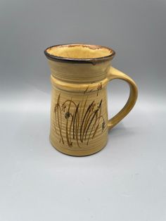 a brown and black coffee cup sitting on top of a table