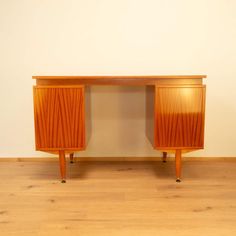 two wooden cabinets sitting on top of a hard wood floor next to a white wall