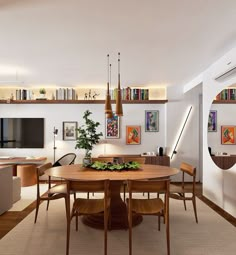 a dining room table surrounded by chairs in front of a television and bookshelves