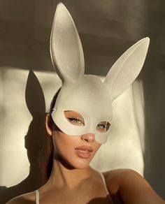 a woman wearing a white bunny mask