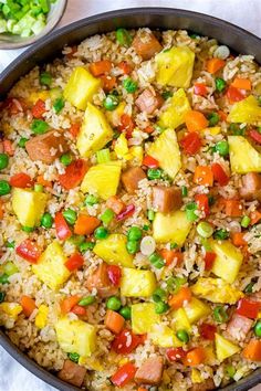 a pan filled with rice and vegetables on top of a table