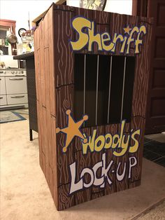 a cardboard box with the words sheriff woody's lock - up on it and an open window