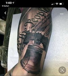 a man with a tattoo on his arm has a bell and the words god's cross