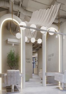 the interior of a salon with white chairs and lights