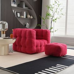 a living room filled with furniture and a large rug on the floor next to a window