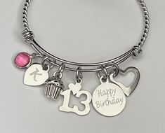 "Birthday bracelet for 13th birthday. Personalized with initial and birthstone. Bracelets are adjustable (60 mm) to fit 6\" to 8 1/2 inch wrist. also available in stainless steel or stainless steel braided in smaller size (55 mm) and fits a teenager wrist best. about 5 to 7 inch wrist. Bracelets are available in 60 mm Silver plated Sterling silver (not charms) Stainless steel Stainless steel braided and Stainless steel diamond cut Also available smaller size 55 mm in stainless steel and stainles Birthday Personalized, Birthday Bracelet, 5 To 7, Cat Charm, Engraved Bracelet, 13th Birthday, Birthstone Bracelets, Heart For Kids, Personalized Keychain