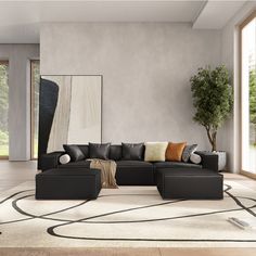 a living room with a large sectional couch and rugs on the floor in front of it