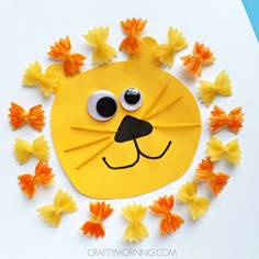 a lion made out of yellow flowers on a white surface with the eyes and nose painted black