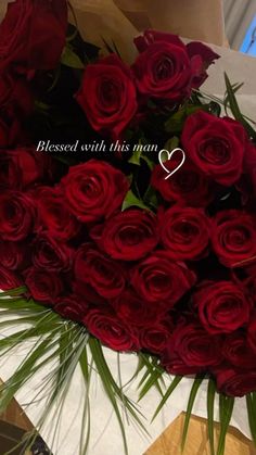 a bouquet of red roses with a message written on it