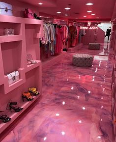 a pink room filled with lots of clothes and shoes