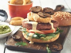 a hamburger sitting on top of a wooden cutting board