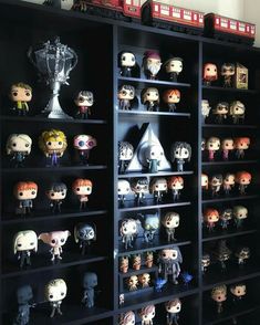 a book shelf filled with lots of harry potter figurines