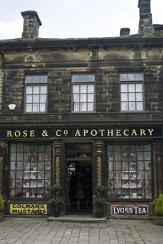 the front entrance to rose & co apothecary in an old brick building