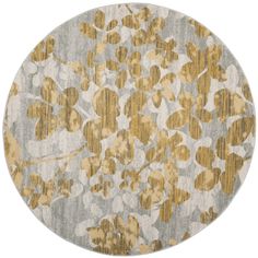 a round rug with gold and gray flowers on it, in the middle of a white background