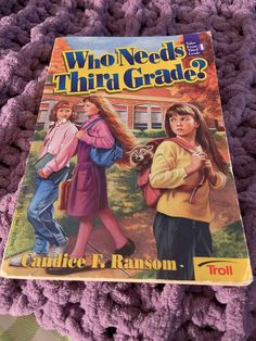 the book who needs third grade? by candice r raason is laying on a pile of purple crocheted yarn