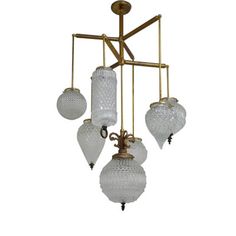 an antique chandelier with five glass globes hanging from the middle of it