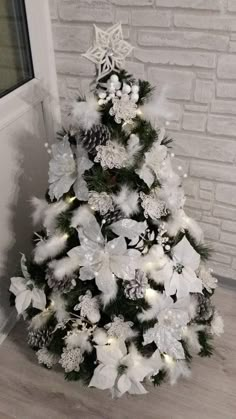 a white christmas tree with snowflakes and lights