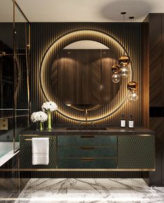 an elegant bathroom with marble counter tops and gold accents, including a round mirror above the sink