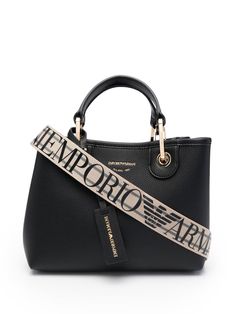 Black logo tag tote bag from EMPORIO ARMANI featuring logo print to the front, logo tag, two top handles, internal zip pocket and gold-tone hardware. | Emporio Armani Logo Tag Tote Bag Armani Logo, Emporio Armani Women, Latest Fashion Design, Logo Tag, Crossbody Clutch, Chanel Deauville Tote Bag, Black Tote, Everyday Bag, Black Logo