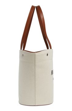 Unbleached canvas made of cotton and linen furthers the casual, go-everywhere appeal of this shapely tote fronted by bold logo lettering. Open top Top carry handles; removable, adjustable crossbody strap Structured silhouette with flat base for stability Textile with leather trim Made in Italy Designer Handbags Beige Canvas Shoulder Bag With Embroidered Logo, Chic Canvas Bags With Logo, Modern Bag With Embroidered Logo For Daily Use, Casual Duck Canvas Tote Bag, Canvas Shoulder Bag With Embroidered Logo And Double Handle, Chic Canvas Shoulder Bag With Logo, Canvas Tote Shoulder Bag With Embroidered Logo, Casual Beige Bag With Logo, Embroidered Logo Coated Canvas Tote Bag