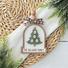 a christmas ornament with a tree on it and the words, the williams family