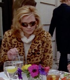 two women sitting at a table with plates of food and drinks in front of them