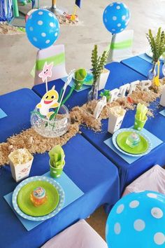 a table set up with blue and green decorations