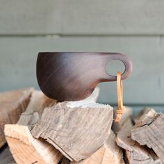 a wooden object sitting on top of a pile of wood