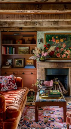 a living room filled with furniture and a fire place in front of a painting on the wall