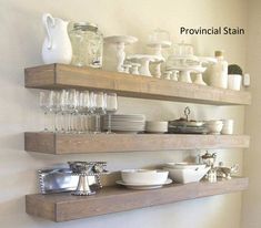 two wooden shelves filled with dishes and glasses