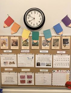 a bulletin board with pictures and a clock on it