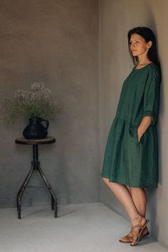 "Handmade in a small family run studio: the dress is handmade with care and attention to detail, emphasizing the craftsmanship and quality. Fabric: The dress is made from high-quality Oeko Tex certified European linen fabrics, offering breathability and comfort. Colors: The dress is available in classic colors, including dark gray, black, dark green, sage green, etc. providing a range of options. Loose-Fitting Design: The loose-fitting design ensures comfort and freedom of movement for everyday wear and special occasions. Stonewashed linen (medium weight 175-205grams)  Long sleeves, wide enough to easy roll them up Hidden side pockets Dress length is about 111 cm / 43.7\" (You can choose other length-please send us a message.) The dress is a loose fit so if you want a more fitted look, ple Relaxed Fit Linen A-line Dress, Relaxed Fit Linen Tunic Dress, Green Linen Dress For Daywear, Green Linen Daywear Dress, Green Relaxed Fit Linen Dress, Green Midi Linen Dress, Midi Linen Dress, Picture Table, Easy Rolls