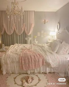 a white bed sitting in a bedroom next to a chandelier and window covered with pink curtains