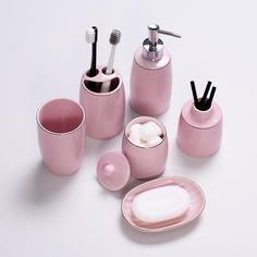 pink bathroom accessories set on white background