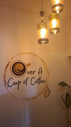 there is a sign that says we are a cup of coffee hanging from the ceiling