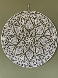 a white doily hanging on the wall