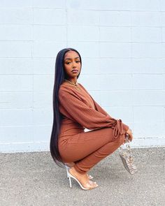 a woman sitting on top of a white chair