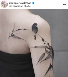 a black and white photo of a woman's shoulder with bamboo leaves on it