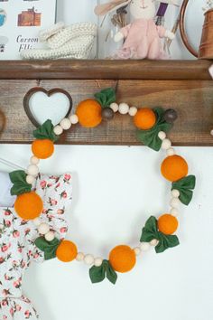 an orange and white wreath is hanging on the wall next to a stuffed animal,