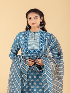 Blue dabu flower printed straight kurta, has a mandarin collar, mirror and katha embroidered yoke, three-quarter sleeves and stripes Print afgani Pants has Elasticated Waistband Fabric: 100% Cotton Color: Blue Note: Available in other colors Wash Care Instruction - Dry Clean Only The product will be shipped within 15-20 days of order placed Size Chart: Kurta Size XS S M L XL XXL XXXL Bust 36 38 40 42 44 46 Waist 32 34 36 38 40 42 Hip 38 40 42 44 46 48 Shoulder 14 14.5 15 15.5 16 16.5 Armhole 18 Indigo Kurta With Dupatta For Eid, Eid Indigo Kurta With Dupatta, Eid Special Indigo Kurta With Dupatta, Blue Cotton Silk Kurta For Spring, Indigo Straight Kurta With Dabka, Indigo Salwar Kameez With Resham Embroidery, Indigo Dabka Straight Kurta, Traditional Indigo Semi-stitched Kurta, Traditional Semi-stitched Indigo Kurta