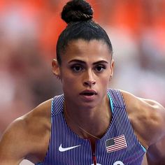 a female athlete with an american flag on her shirt