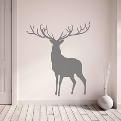 a deer with antlers is shown on the wall